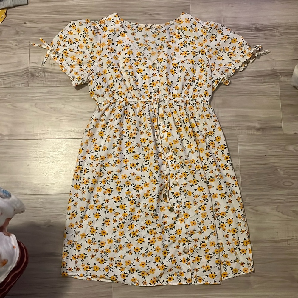 XL White dress with little yellows flowers on it.